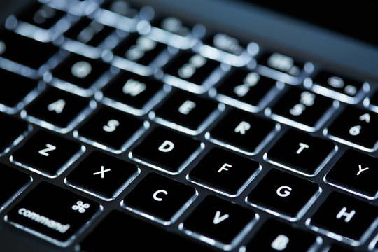 Keyboard laptop. Backlit computer keyboard closeup. Hi tech concept