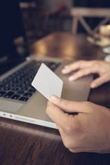 Attractive woman with credit card and laptop