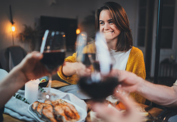 Best friends dining together at home clinking with glasses of red wine, cozy atmosphere, group of people celebrating birthday party at home, Family Dinner Celebrate Friendship Concept