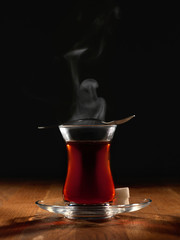 Hot Turkish tea with spoon and two sugars.