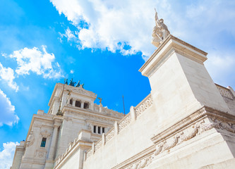 Fototapeta premium Ancient Europe Italy architecture monument - Rome Vittoriano palace (view from below) on sunny day with clouds on the blue sky
