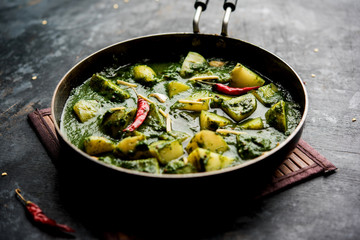 Aloo Palak sabzi or Spinach Potatoes curry served in a bowl. Popular Indian healthy recipe. Selective focus