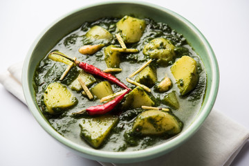 Aloo Palak sabzi or Spinach Potatoes curry served in a bowl. Popular Indian healthy recipe. Selective focus