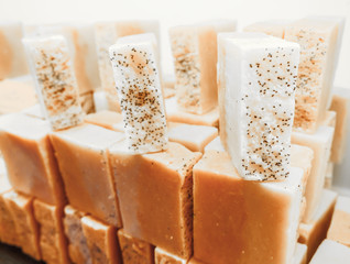 Bars of soap on a shop window. Ylang-ylang soap with natural cedar oil and herbal ingredients. Handmade natural cold process soap. Eco-friendly exfoliating soap for hair and body