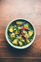 Aloo Palak sabzi or Spinach Potatoes curry served in a bowl. Popular Indian healthy recipe. Selective focus