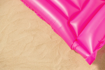 vacation and summer holidays concept - pink swimming mattress on beach