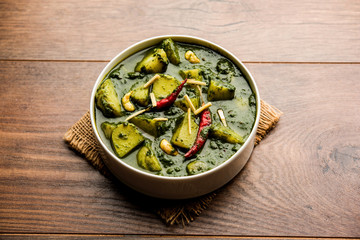 Aloo Palak sabzi or Spinach Potatoes curry served in a bowl. Popular Indian healthy recipe. Selective focus