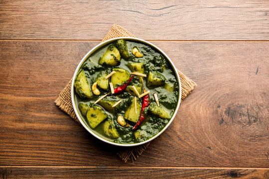 Aloo Palak sabzi or Spinach Potatoes curry served in a bowl. Popular Indian healthy recipe. Selective focus