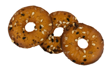 Three bite size bagel chip with seeds on a white background