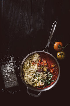 Overhead view of pasta with tomato basil sauce in saucepan