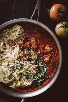 Close up of pasta with tomato basil sauce in saucepan