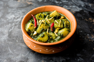 Aloo Palak sabzi or Spinach Potatoes curry served in a bowl. Popular Indian healthy recipe. Selective focus