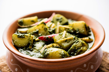 Aloo Palak sabzi or Spinach Potatoes curry served in a bowl. Popular Indian healthy recipe. Selective focus