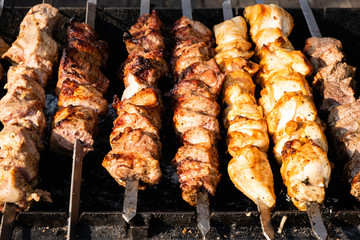 fresh grilled meat on skewers on grill