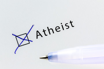 Atheist - checkbox with a cross on white paper with blue pen. Checklist concept