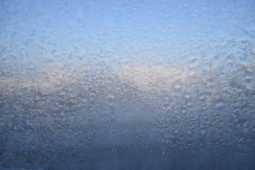Frozenned glass, ice on window, winter icy cristmas background. Ice patterns on glass