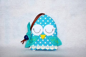 DIY handmade key cover owl doll pattern made from colorful fabric and leather and plastic beads in workshop thai style