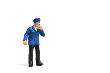 Miniature people : Policeman standing on white background