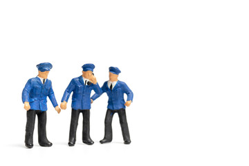 Miniature people : Policeman standing on white background