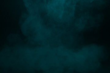 Obraz na płótnie Canvas Colorful smoke close-up on a black background