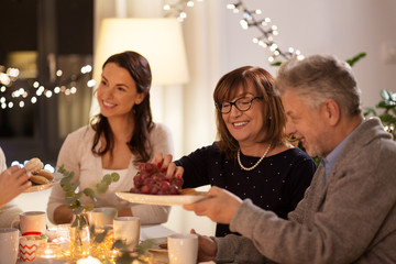 celebration, holidays and people concept - happy family having tea party at home