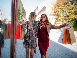 Smiling shopping girl with bags in the city - spring sales