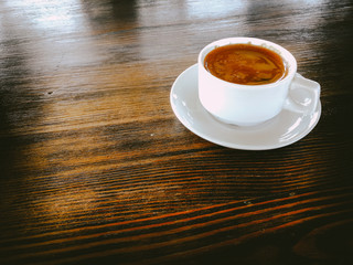 a Cup of natural black coffee on a wooden table in a seaside cafe