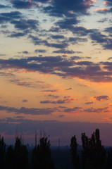 Landscape with dramatic light - beautiful golden sunset with saturated sky and clouds.