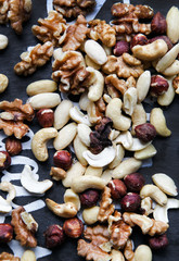 Natural background made in nuts. Hazelnut, walnut and cashew background.