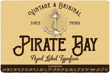 Vintage label typeface named Pirate Bay. Strong original logo font. Capital and small letters with numbers. Hand drawn illustration of anchor.