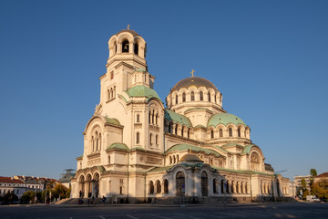Fototapeta na wymiar Side view of Alexander Nevsky Orthodox Cathedral of Sofia, Bulgaria under a blue sunny sky