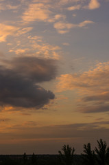 Landscape with dramatic light - beautiful golden sunset with saturated sky and clouds.