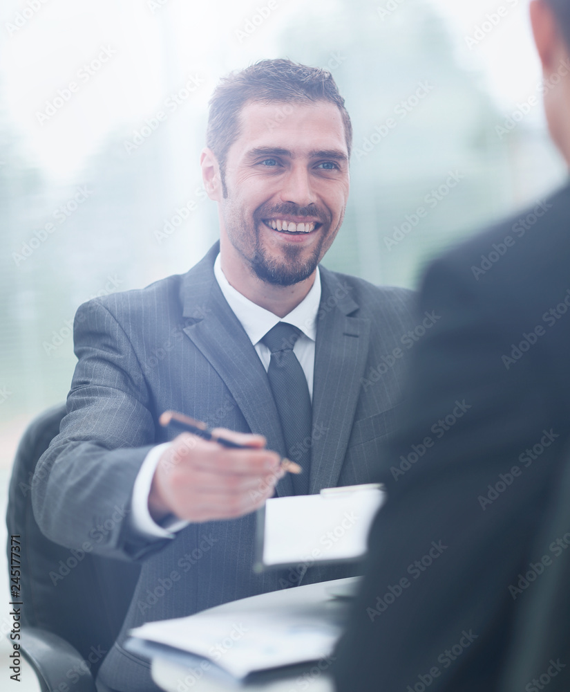 Wall mural closeup.a successful businessman, signing a lucrative contract