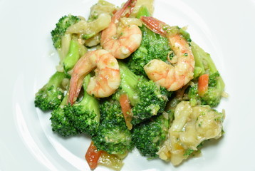 stir fried broccoli with shrimp and crispy chicken on dish