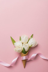 Flat-lay waffle cone with white flower blossom
