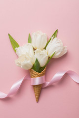 Flat-lay waffle cone with white flower blossom