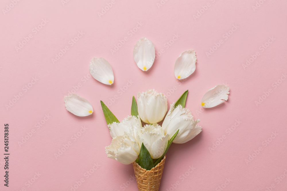 Wall mural Flat-lay waffle cone with white flower blossom