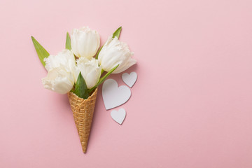 Flat-lay waffle cone with white flower blossom