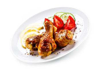 Drumsticks with vegetables on white background