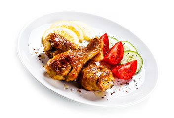 Drumsticks with vegetables on white background
