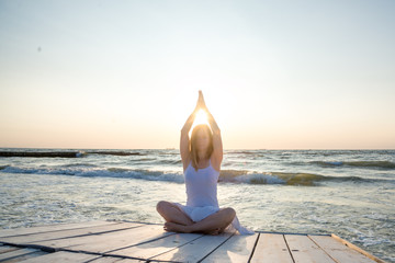 Woman meditating at the sea