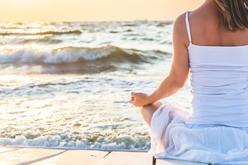 Fototapeta na wymiar Woman meditating at the sea