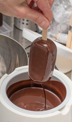 a covered icecream with melting chocolate at a icecream shop