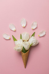 Flat-lay waffle cone with white flower blossom