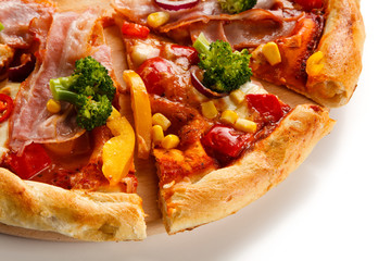 Pizza with bacon and vegetables on cutting board on white background
