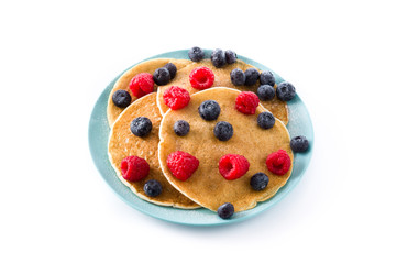 Pancakes with raspberries and blueberries isolated on white background

