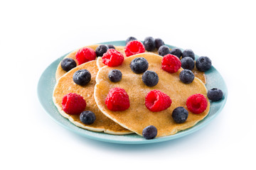 Pancakes with raspberries and blueberries isolated on white background


