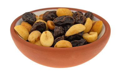 Small bowl filled with peanuts and raisins isolated on a white background.