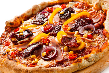 Pizza with ham, corn, mushrooms and dried tomatoes on white background