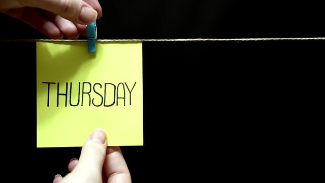 Two multicolored stickers. Emotion. On left yellow a sheet inscription Thursday. On the pink page on face an expression of love.